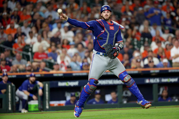 Texas Rangers catcher Jonah Heim throws to first for an out during the sixth inning of Game 7 of the ALCS against the Houston Astros at Minute Maid Park.